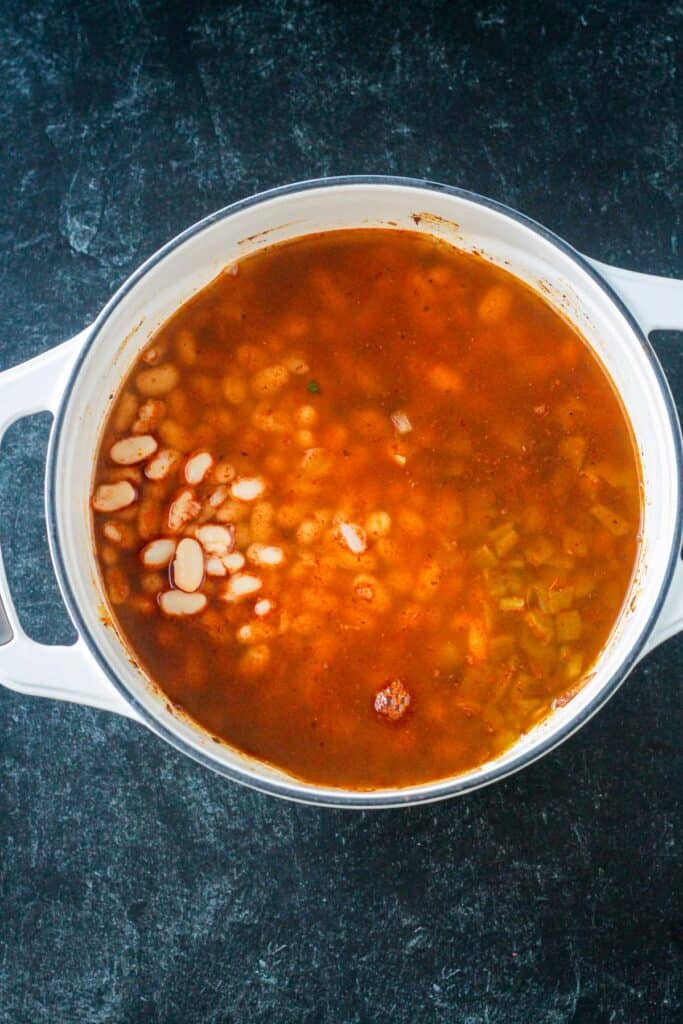 Beans, broth, and diced green chiles added to the pot.