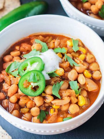 Vegan white chili with chickpeas topped with jalapeño slices.