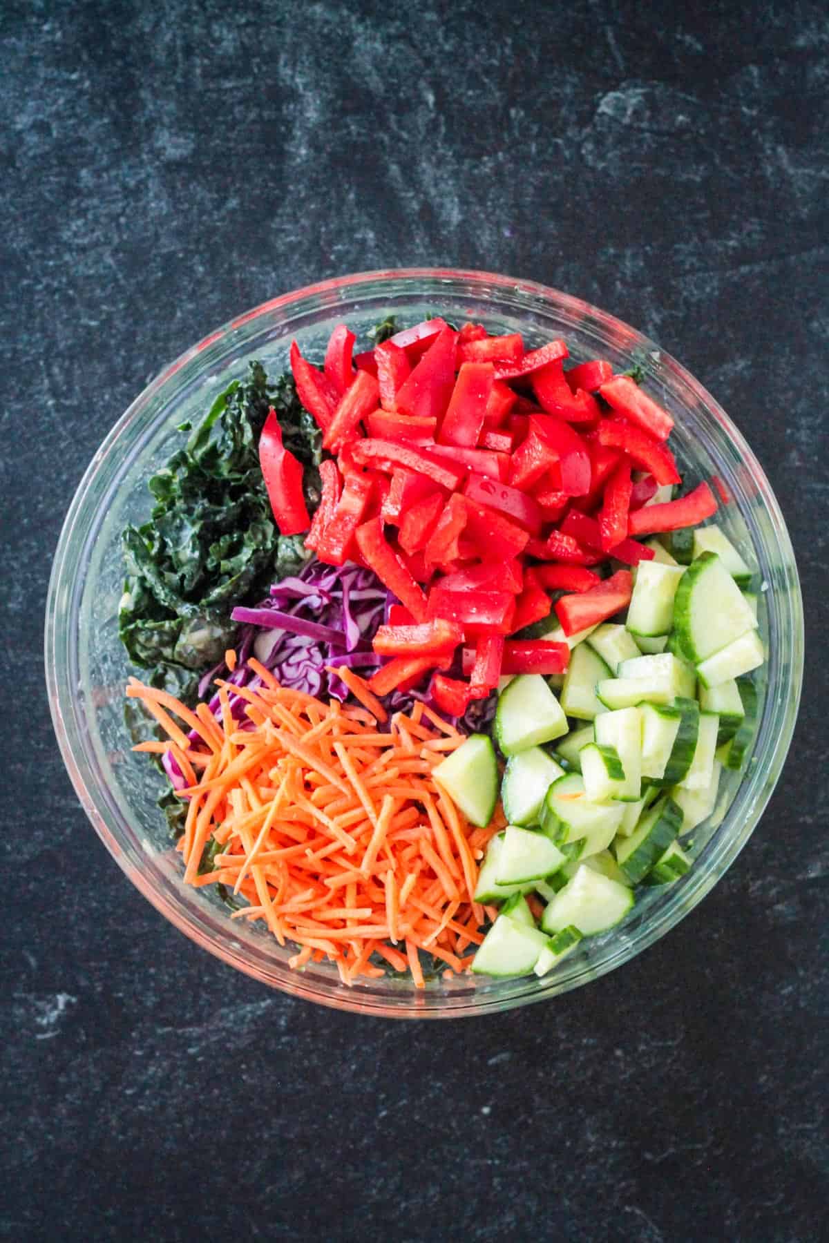 Sliced red bell peppers add to the bowl.