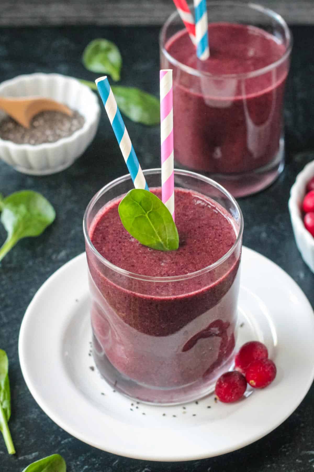 Coconut Water Smoothie w/ Berries & Spinach - the perfect smoothie to rehydrate and load you up on nutrients after an illness or to keep you feeling your best any time of the year! Coconut water smoothie in a glass.