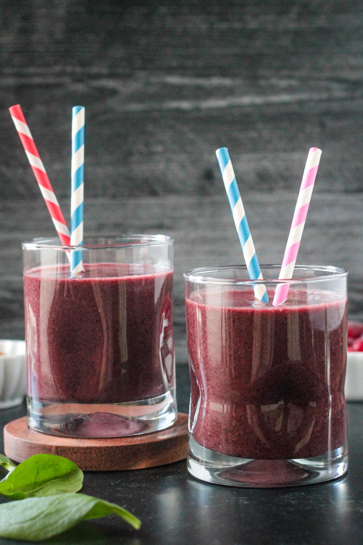 Two smoothie glasses next to each other.