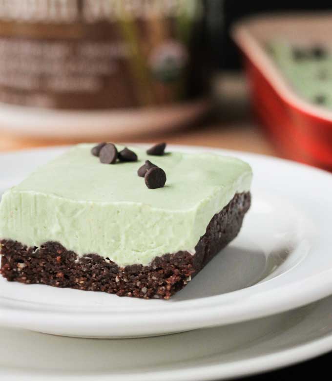 Square slice of vegan grasshopper pie on a white plate.