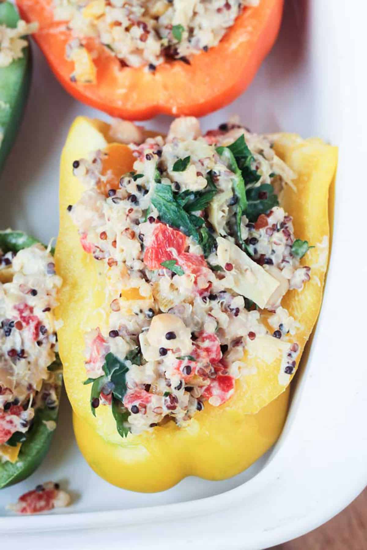 Close up of quinoa and chickpea filling in a halved yellow bell pepper.