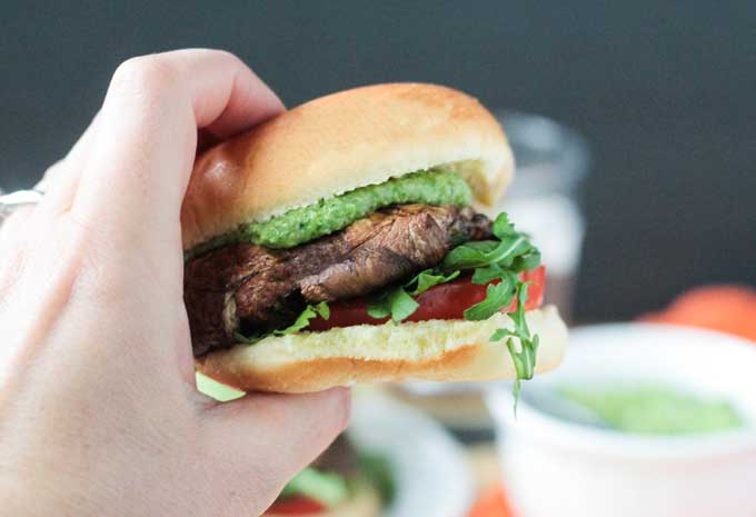 Hand holding a portobello slider burger