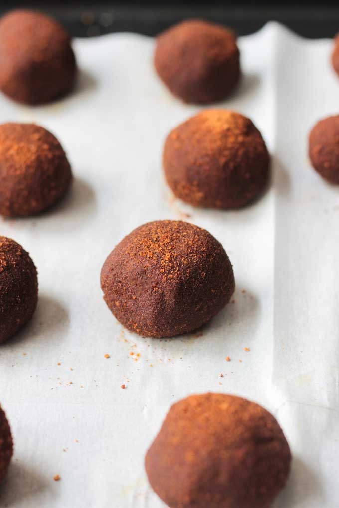 Cinnamon Chickpea Cashew Cheesecake Bites on a baking sheet lined with parchment paper.