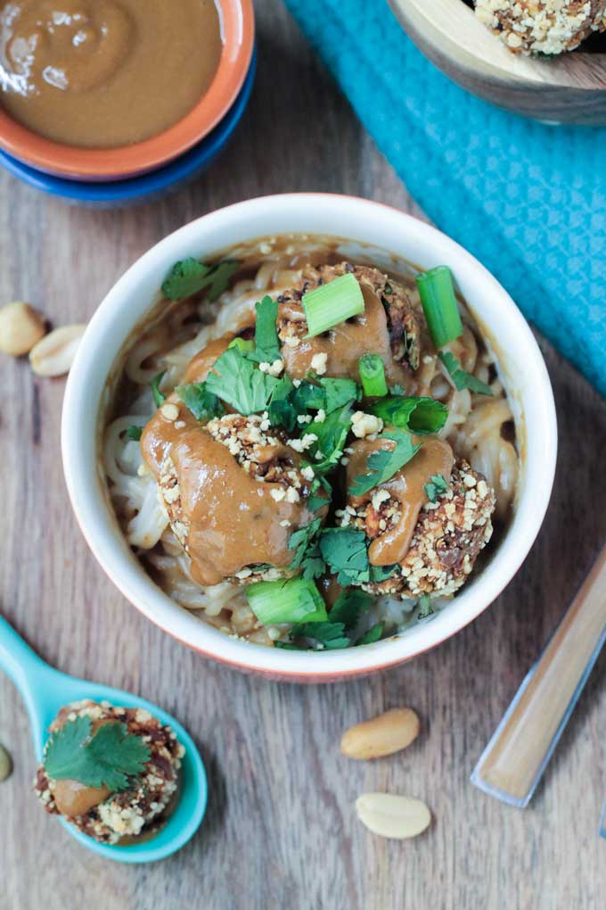 Thai Quinoa Meatballs over rice noodles and garnished with crushed peanuts, cilantro, and scallions.