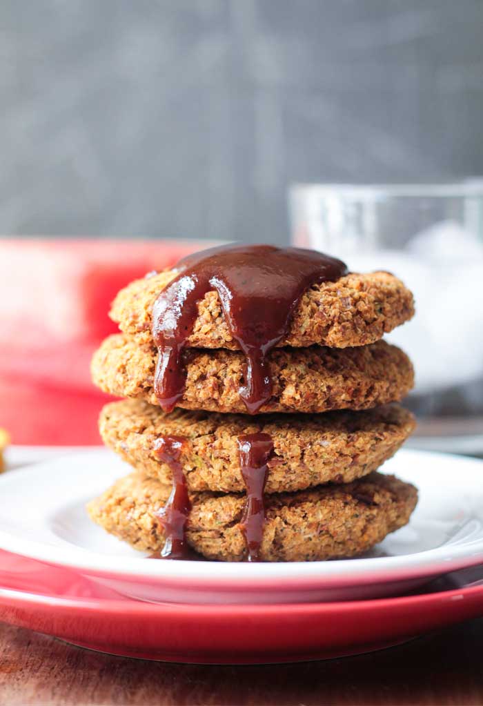 Stack of 4 Smoky Millet Pinto Bean Patties drizzled with BBQ Sauce.