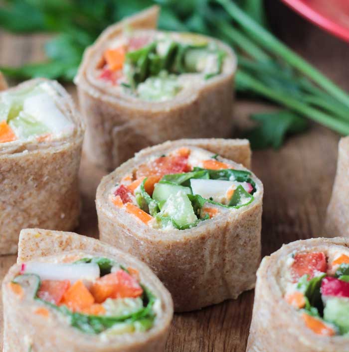 Cucumber, peppers, carrots, and cream cheese, in bite size tortilla rollups.