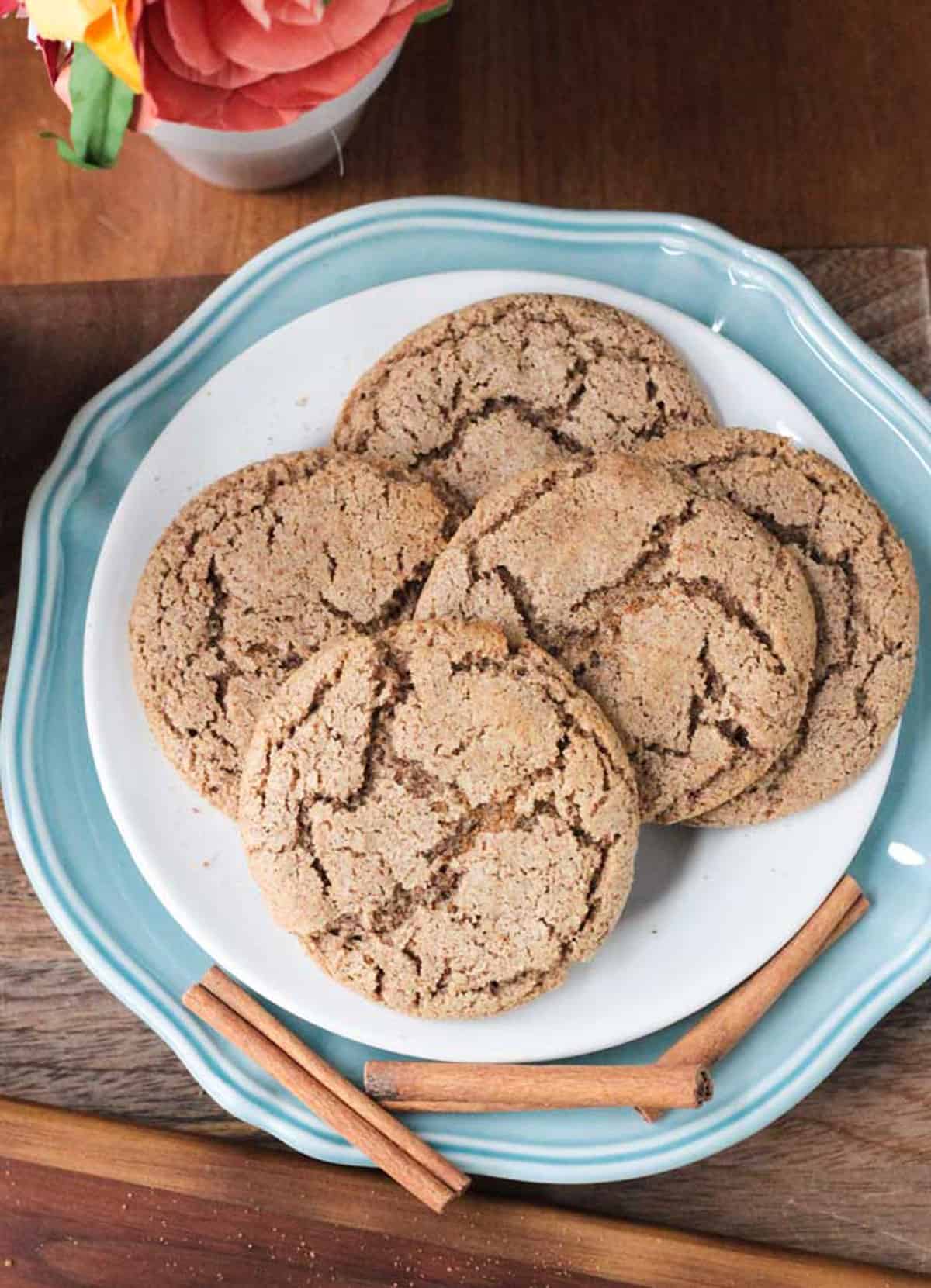 Cinnamon Sugar Cookies - perfectly crispy on the outside, chewy on the inside, sweet, delicious, and packed with warm cinnamon. Only 6 ingredients and 15 minutes needed to make these quick and easy, gluten free cookies! They're going to become your go-to sweet treat! A pile of Vegan Cinnamon Cookies on a plate.