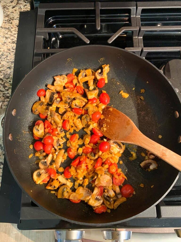 Sautéed mushrooms with tomatoes and onions.