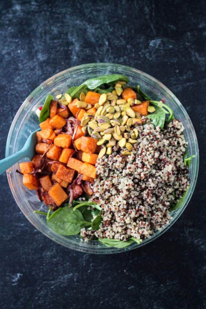 Salad components arranged in a mixing bowl.