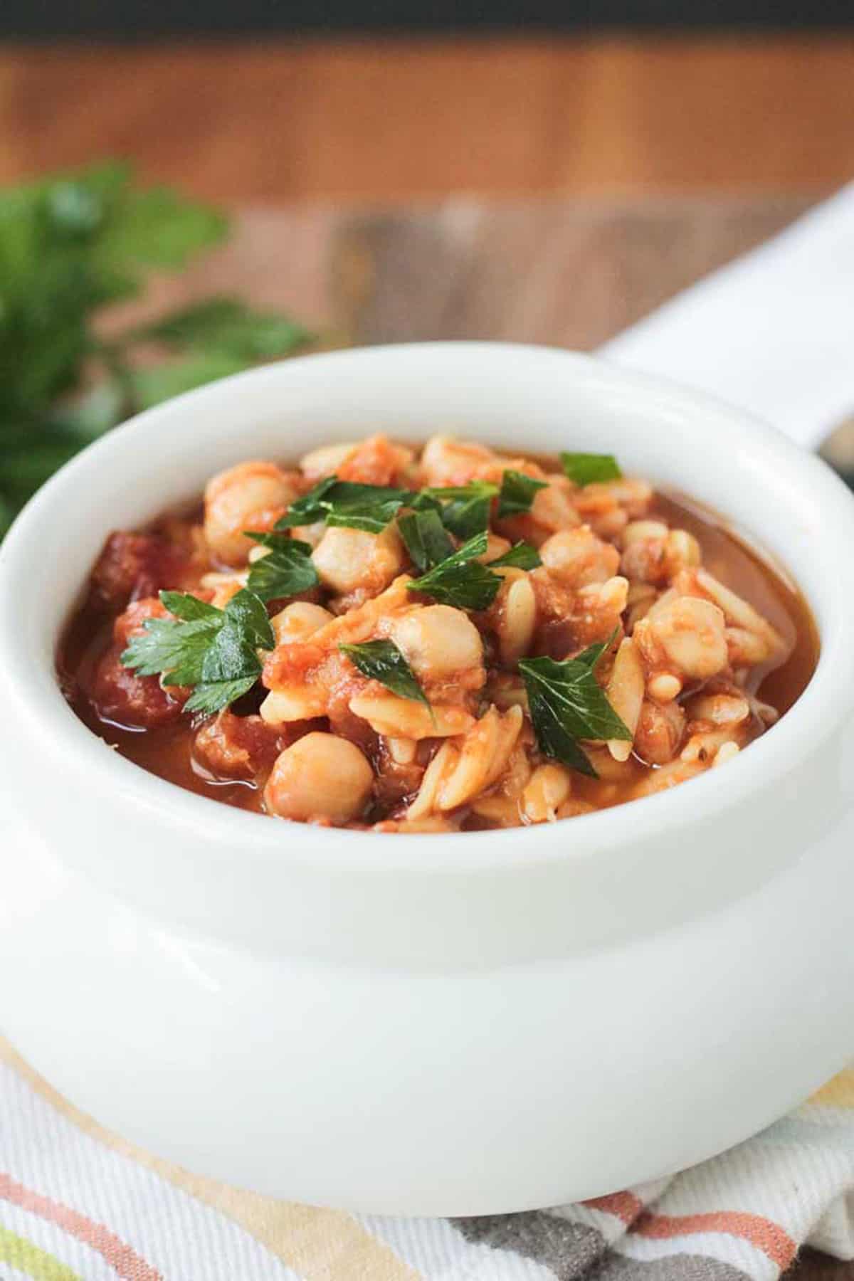 Close up of chickpeas in red lentil stew.