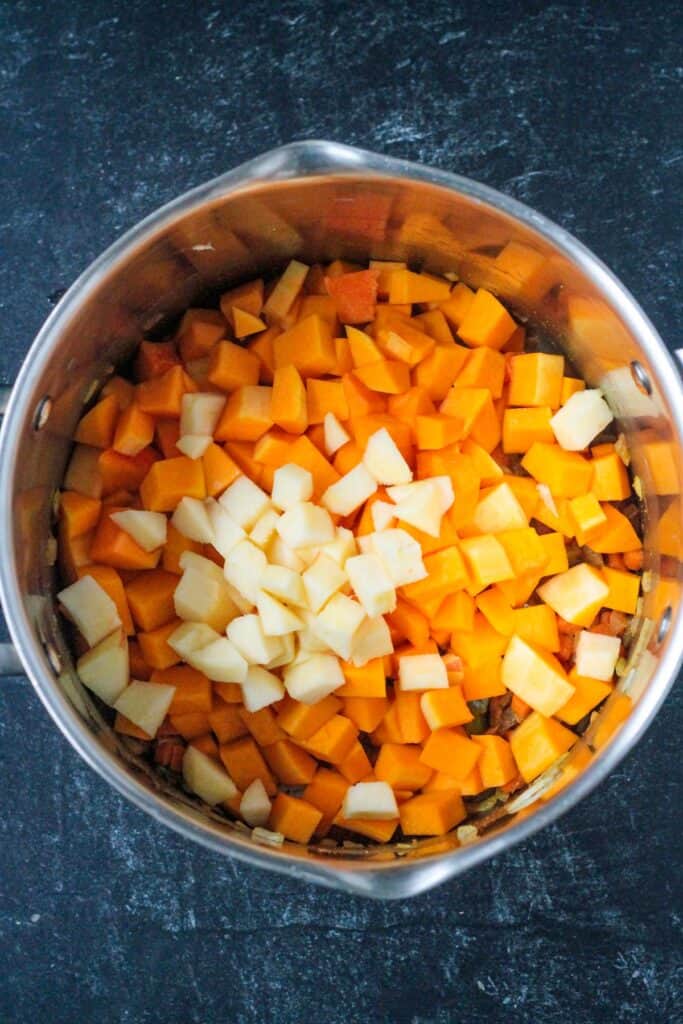 Diced butternut squash and apples added to the pot.