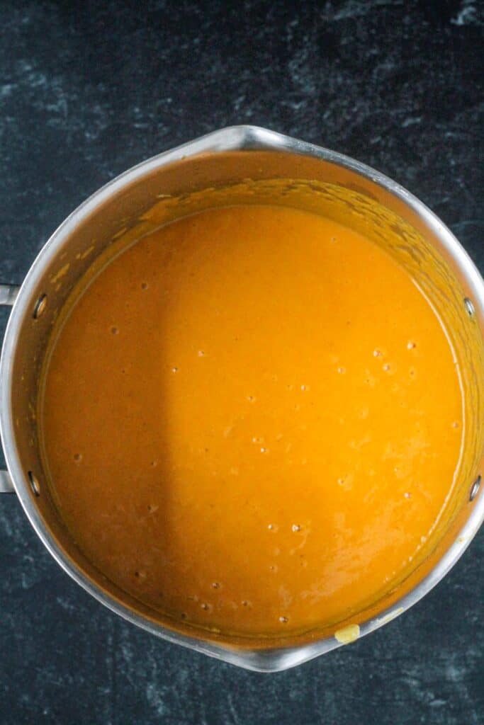 Silky smooth butternut squash soup after being puréed.