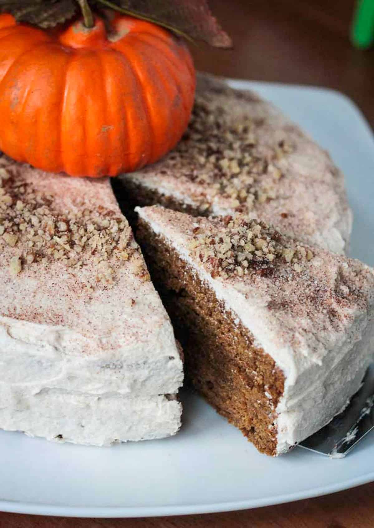 One slice of cake being cut from a whole cake.