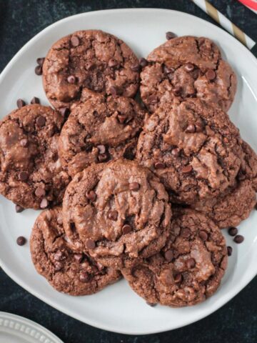 Stack of five almond flour chocolate cookies on a plate.