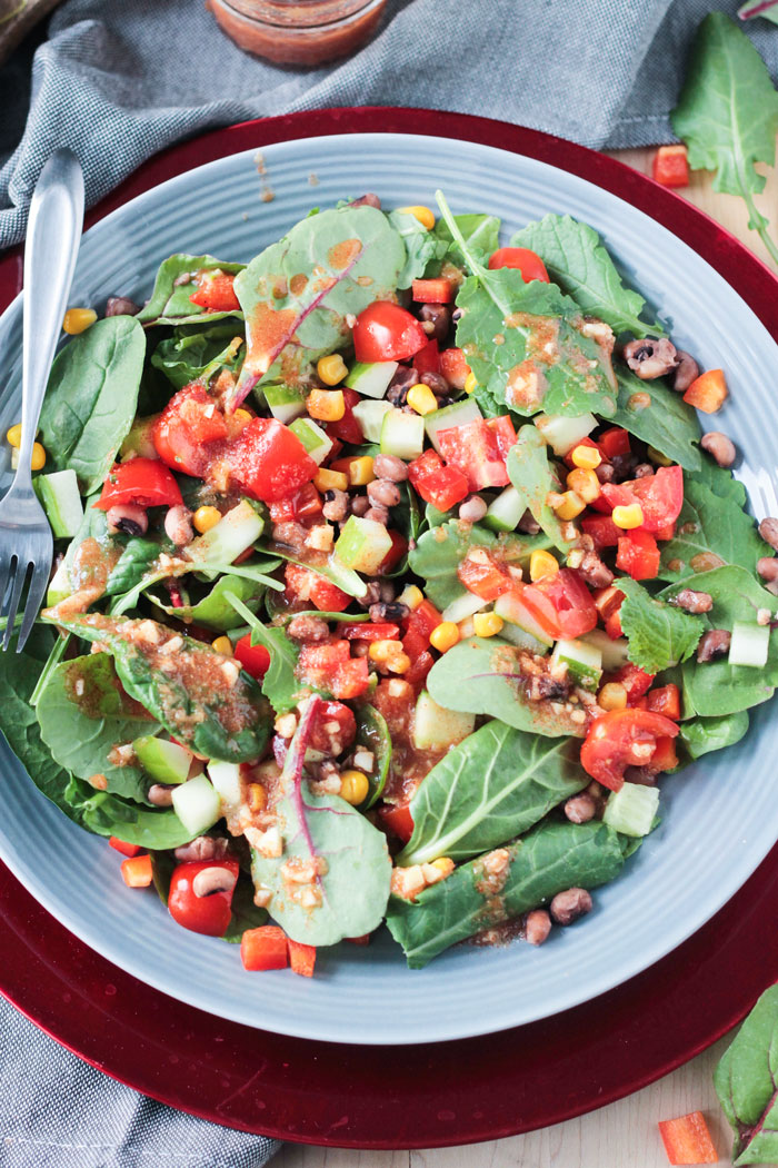 Black Eyed Peas Salad w/ Baby Power Greens, tomatoes, peppers, and corn.