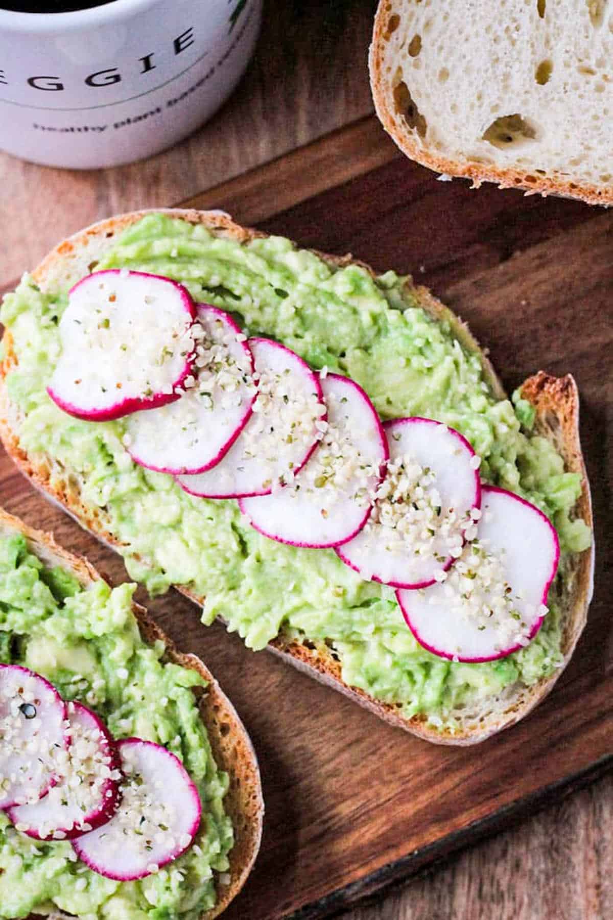 Vegan avocado toast with thinly sliced radishes and hemp seeds.
