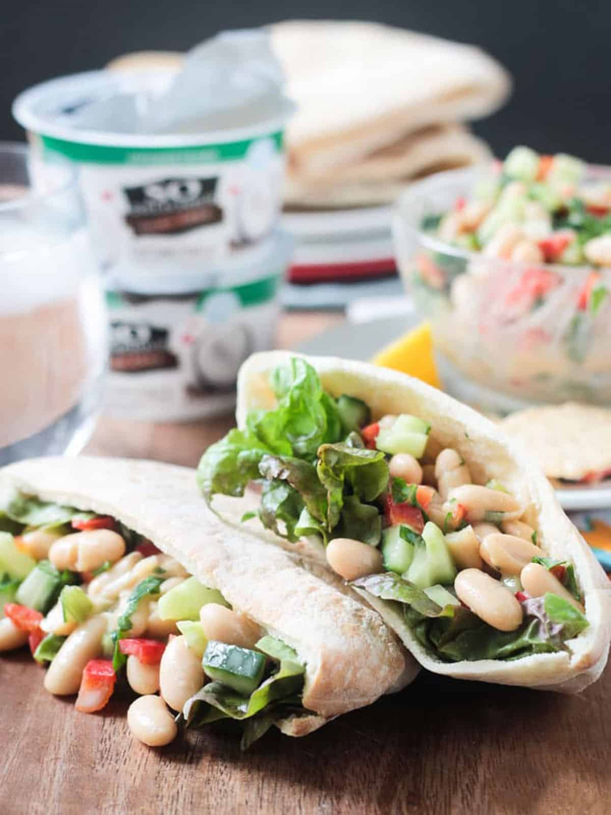 White beans, cucumber, red bell pepper and lettuce in a pita pocket.