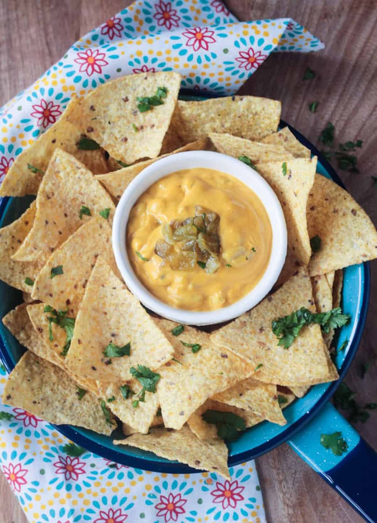 bowl of cheese dip surrounded by chips