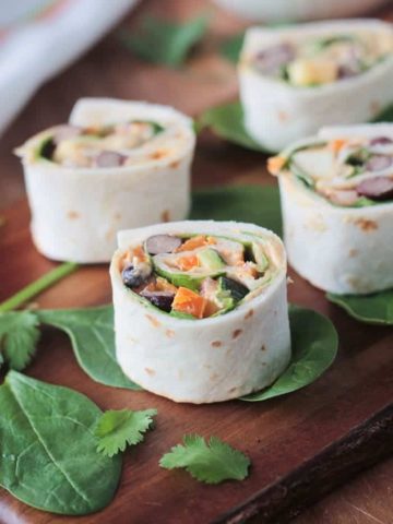 Southwest Roll Ups - the perfect party appetizer for your vegetarian and vegan friends. Full of flavor and protein, these little bites will please meat eaters too!