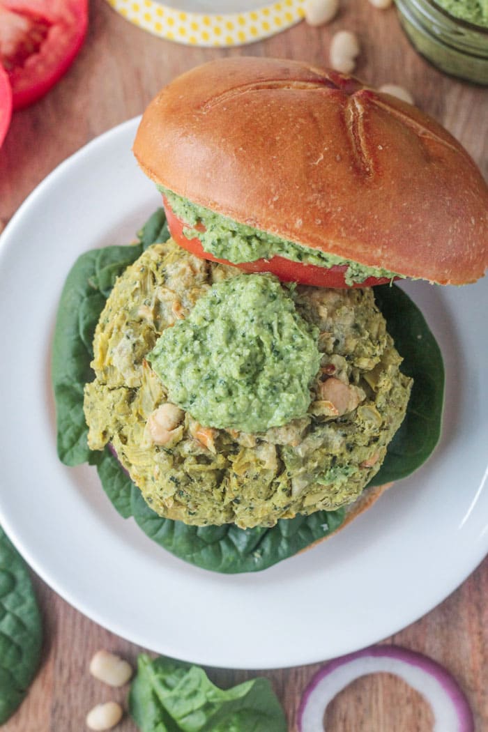 Spinach Artichoke White Bean Burger topped with pesto.