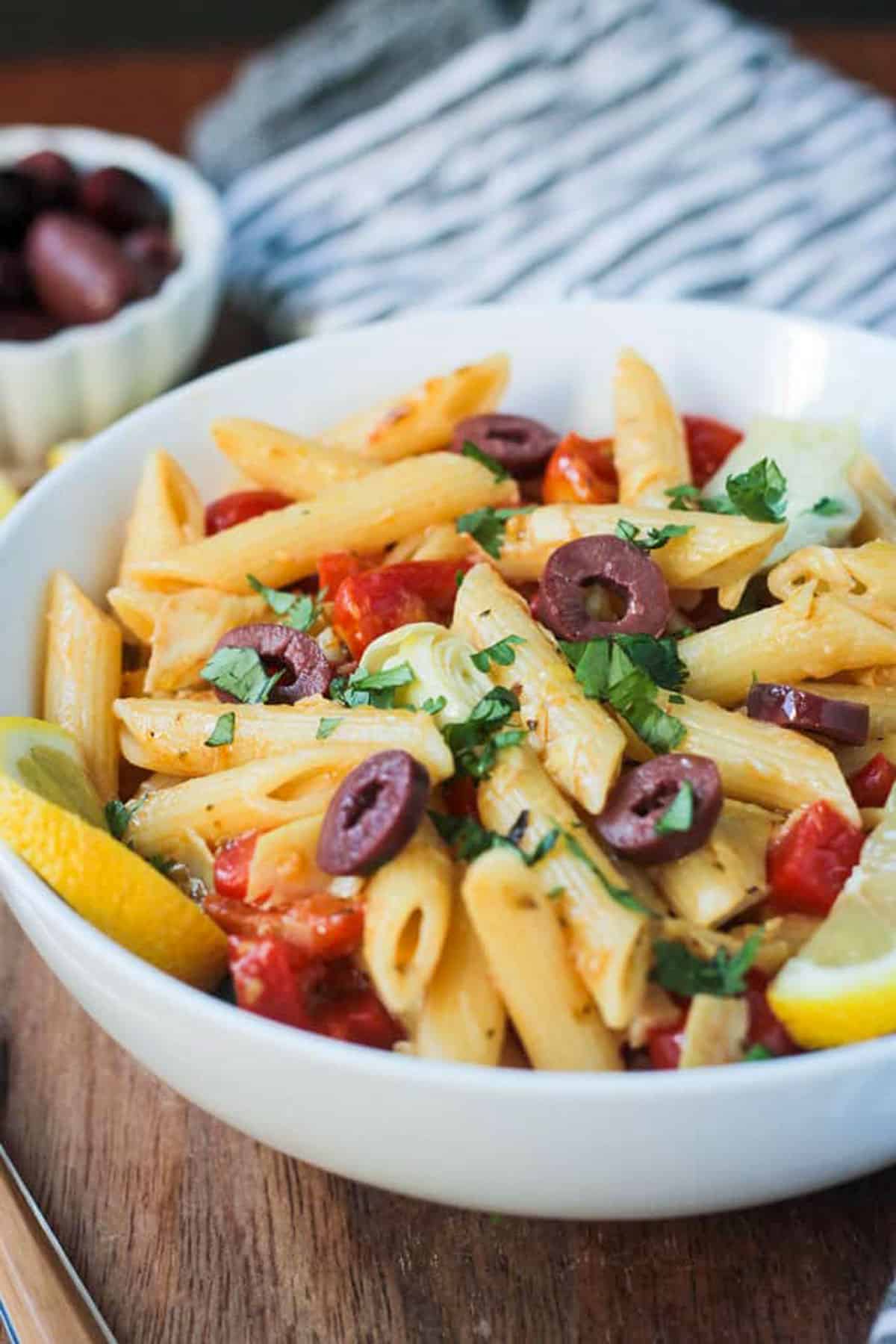 Pasta with peppers, artichokes, tomatoes, and olives.