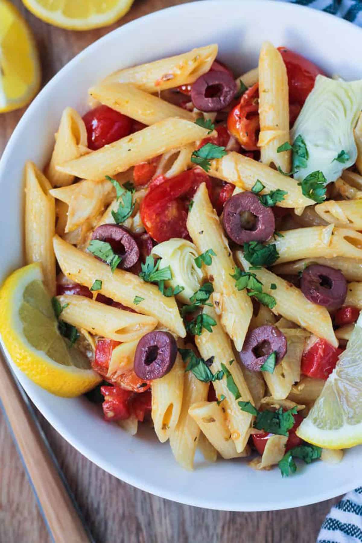 Close up of penne pasta with vegetables.