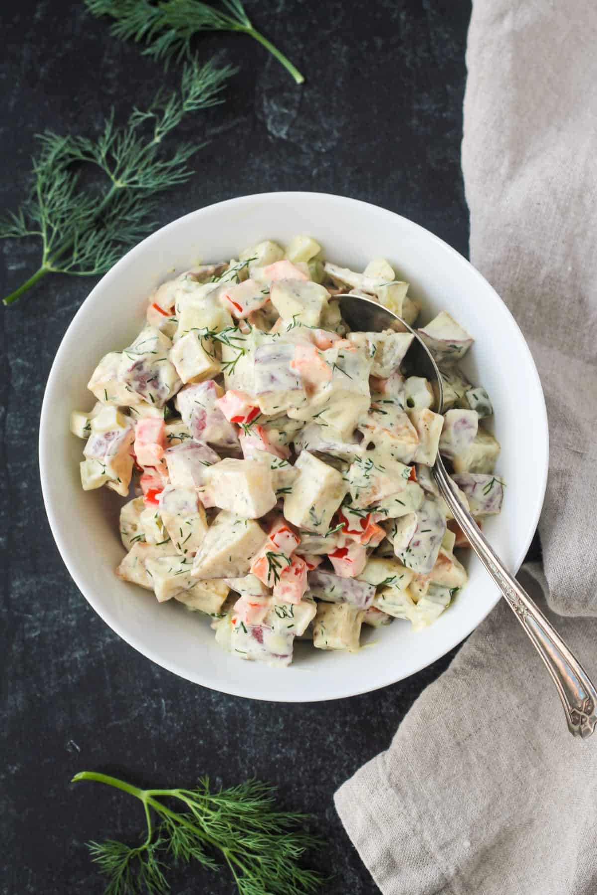 Vegan red roasted potato salad in a serving bowl.