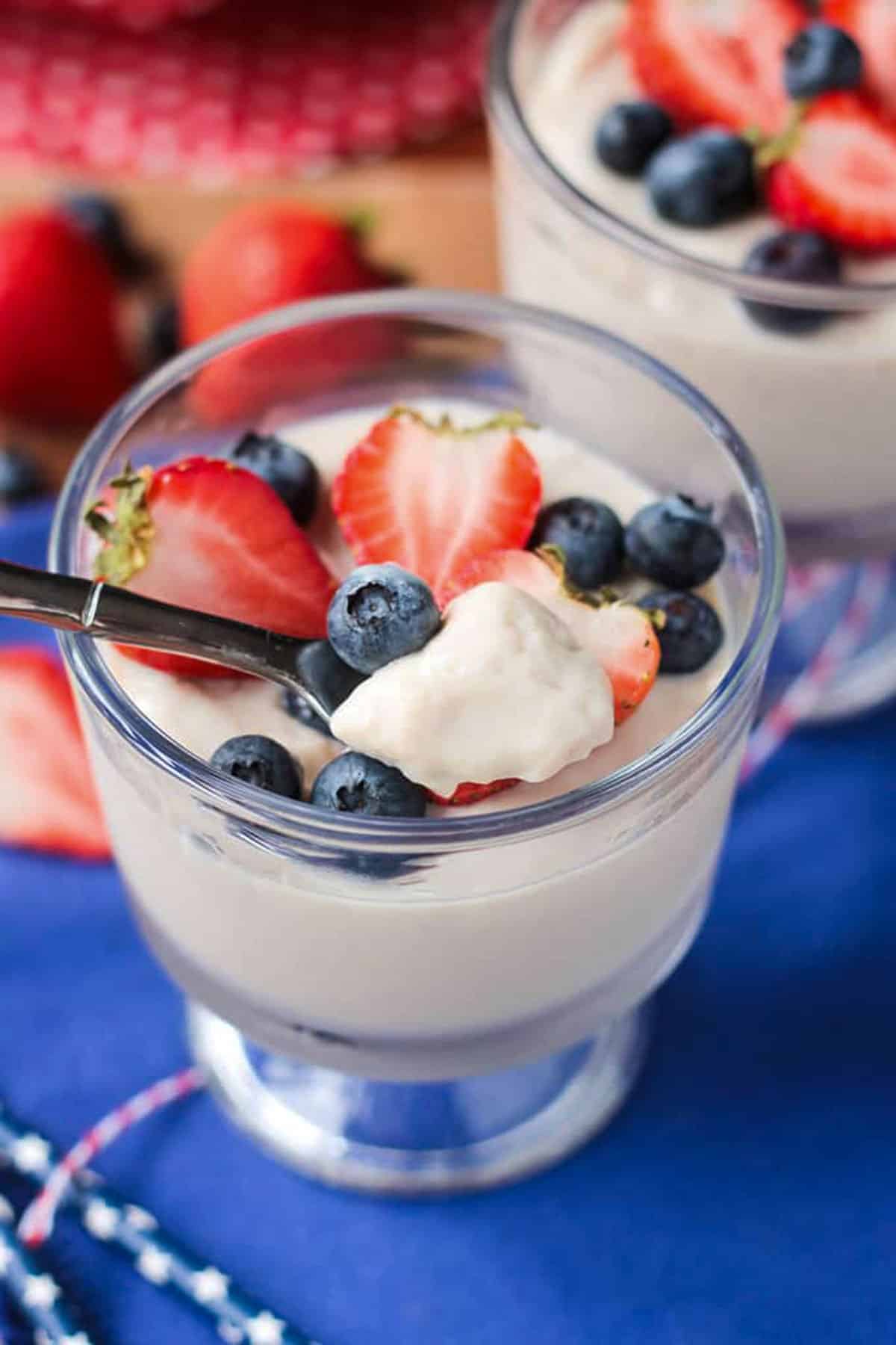 Bite of pudding and fresh berries on a spoon.