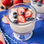 Vegan vanilla pudding in a glass bowl topped with fresh berries.