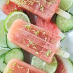 Close up shot of a watermelon popsicle garnished with lime zest.