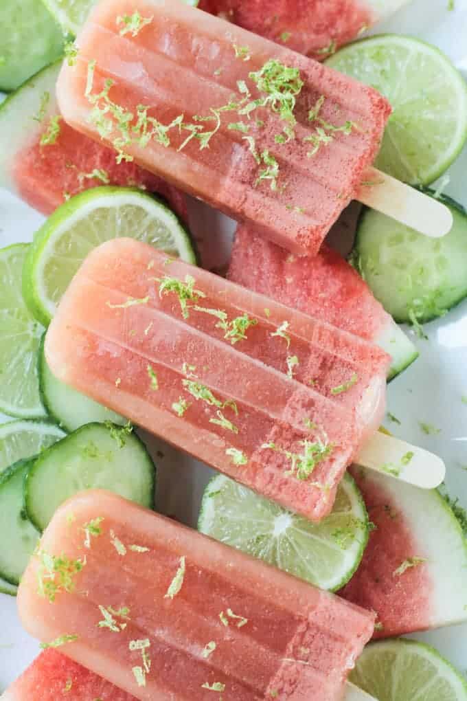 Close up shot of a watermelon popsicle garnished with lime zest.