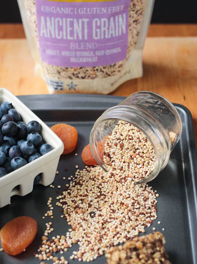 Jar of Village Harvest Ancient Grains blend spilling out onto a tray.