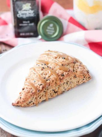 Banana Scone w/ black sesame seeds on a white plate.