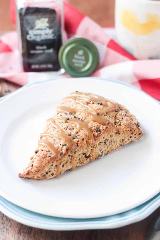 A single banana black sesame eggless scone on a white plate.