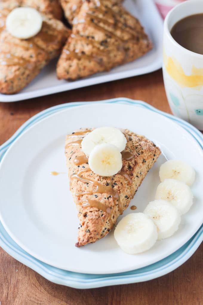 Pastry topped with banana slices with more banana slices lying on the plate.