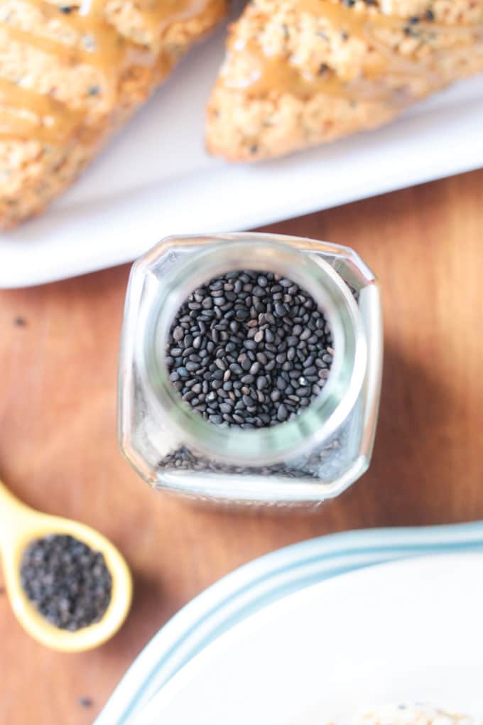 Overhead shot looking into a spice container of black sesame seeds.