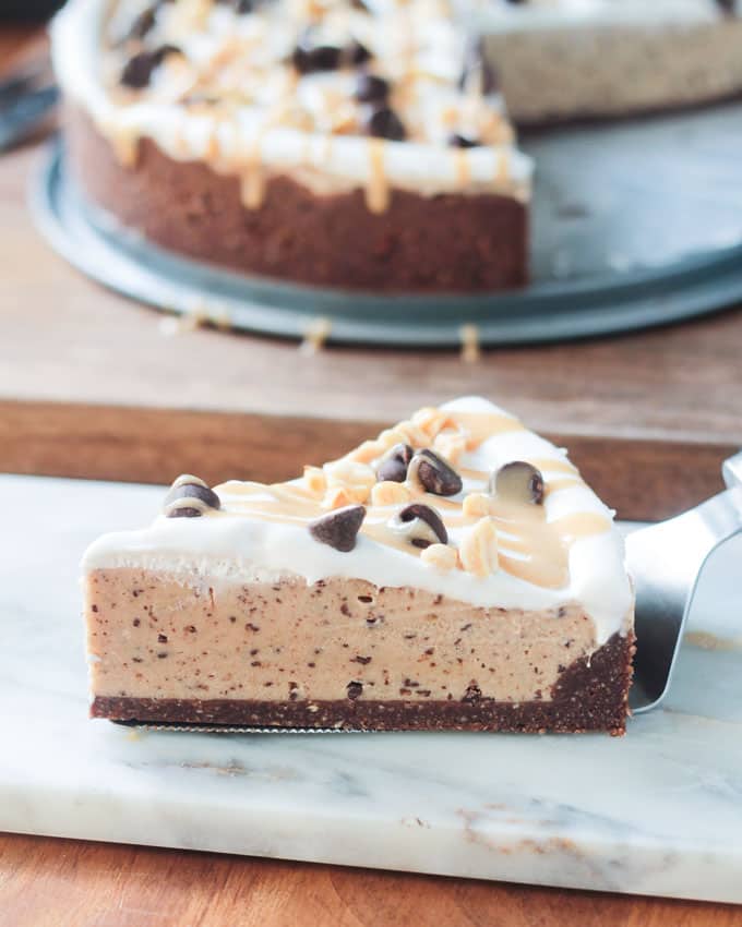 Slice of Chocolate Peanut Butter Frozen Pie on a white marble slab.