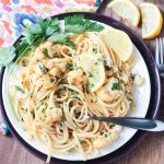 Plate of Cauliflower Scampi in Lemon Garlic White Wine Sauce garnished with wedges of lemon and fresh parsley.