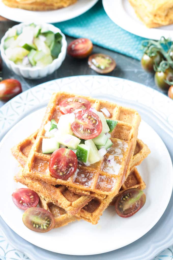 Stack of vegan savory waffles topped with fresh garden salsa.