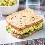 Overhead view of Curried Tofu Salad Sandwich on whole grain bread.