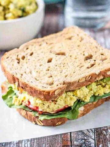 Overhead view of Curried Tofu Salad Sandwich on whole grain bread.