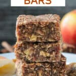 Stack of three apple oat date bars on a white plate.