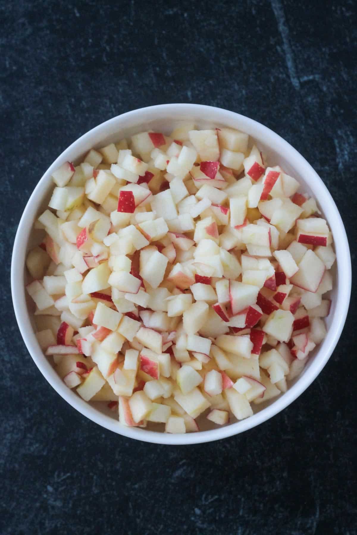 Finely diced apples in a bowl.