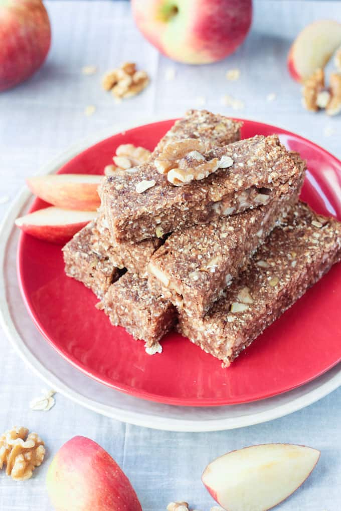 Stack of apple pie bar on a red plate.