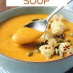 Spoonful of soup being lifted out of the bowl.