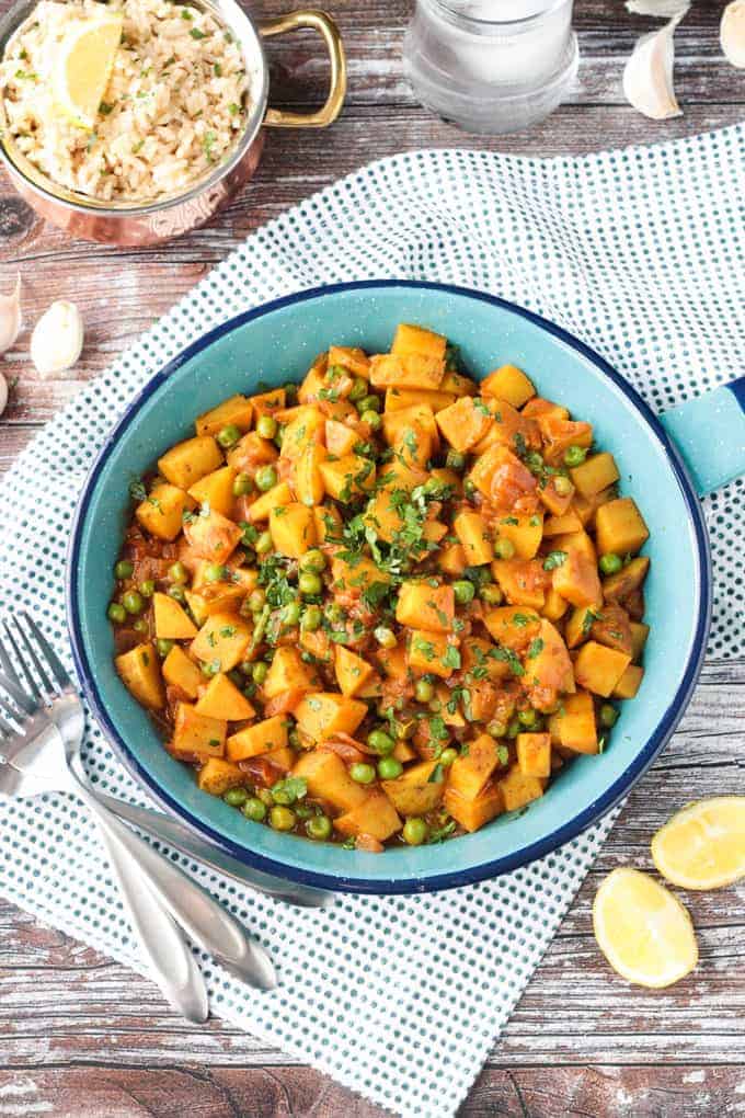 Skillet full of potatoes and peas.