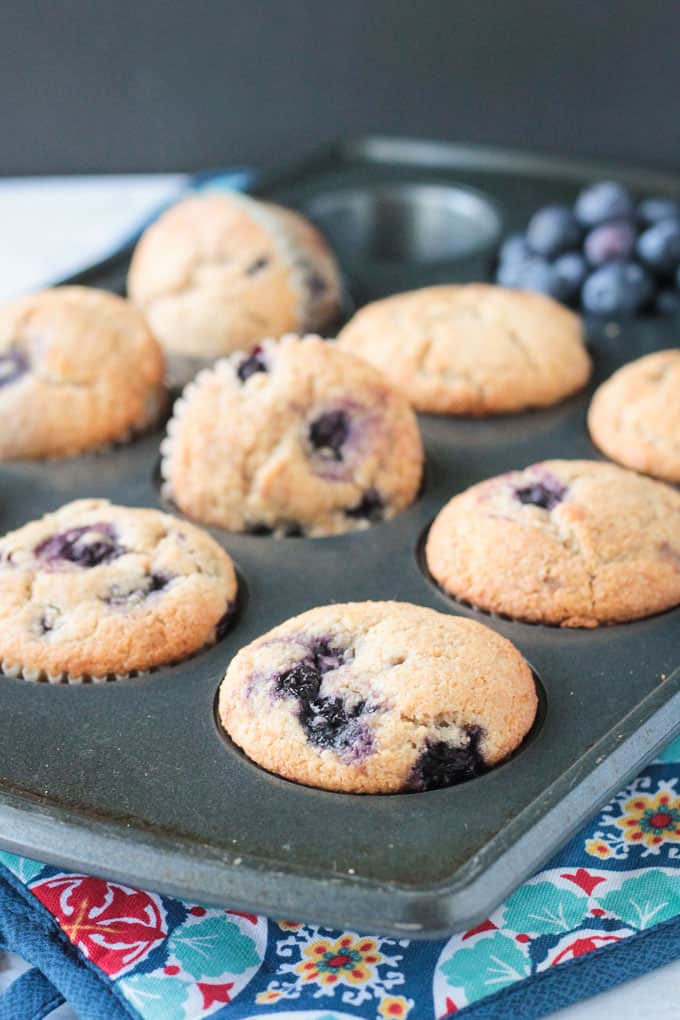 Close up of tray blueberry muffins in the muffin tin.