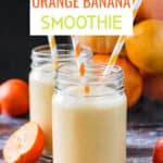 Two glasses of orange banana smoothie with orange and white striped straws.